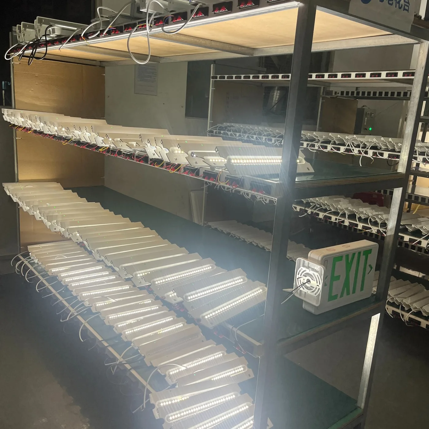 Emergency lights undergoing powered aging tests
